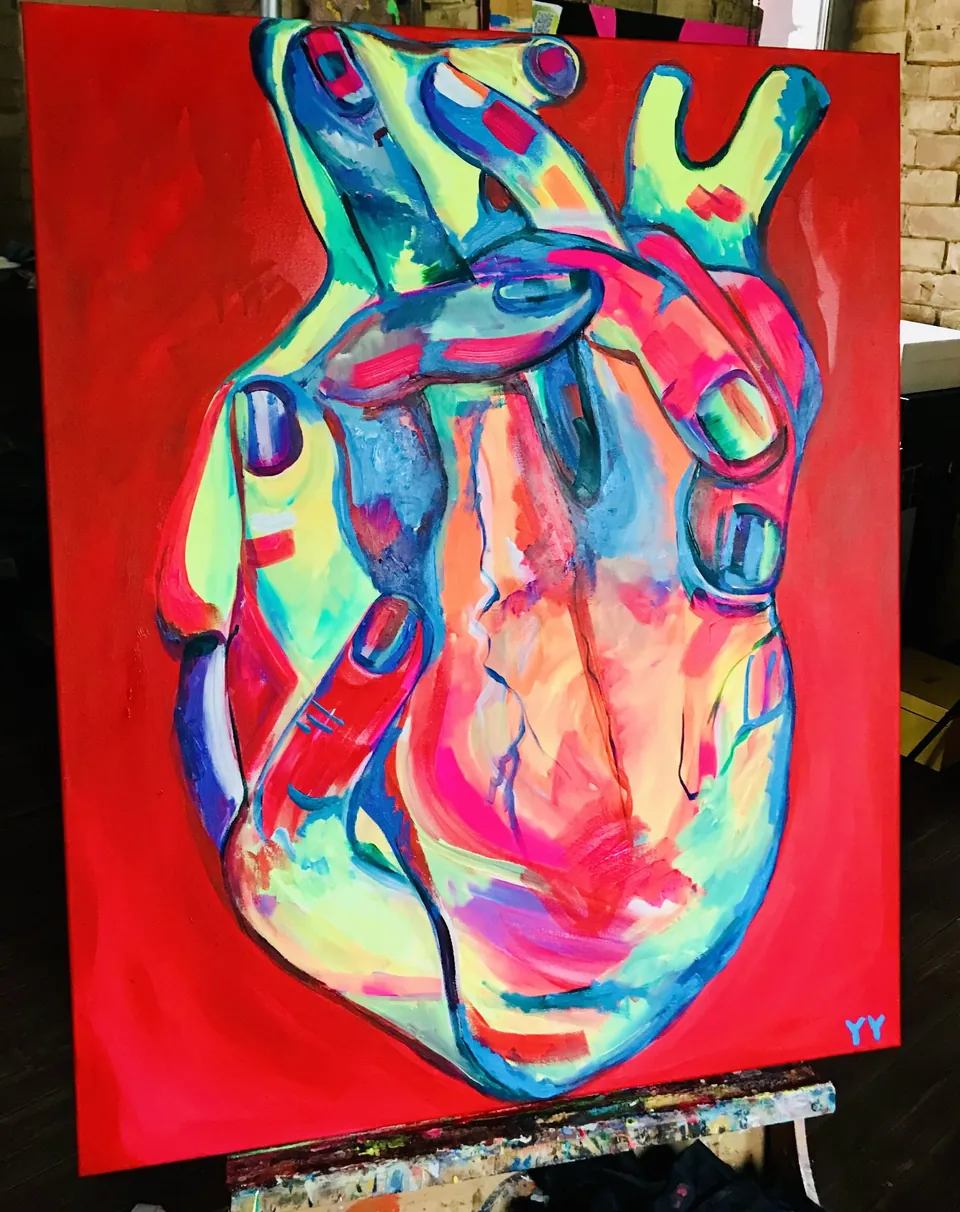 Neon Heart by Yana Yank: an anatomical human heart painted in neon pink, turquoise and blue on a vivid red background